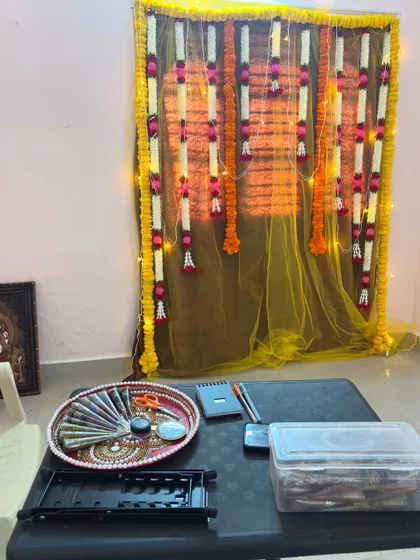 My workspace is always ready for creativity. This is a typical setup for a home client visit, complete with fresh henna cones and a decorated backdrop to create a festive atmosphere.