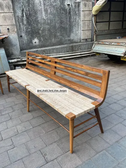One of the benches, highlighting the elegant curve of the backrest and the clean lines of the design.