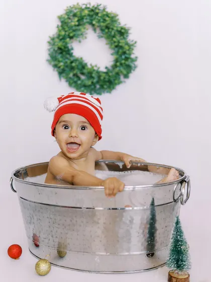 A happy baby enjoying a festive bath. Even our bathtub sessions can get a touch of holiday magic.