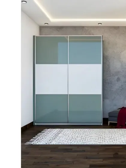 A modern sliding wardrobe with a two-tone design of white and grey-green glass panels. This minimalist design provides ample storage while maintaining a light and airy feel in the room.