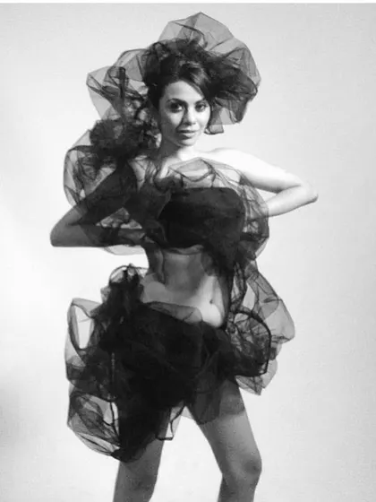 An artistic, monochrome shot exploring the beauty of sheer, draped fabric. The blurred motion and soft focus create a dreamy, ethereal quality.