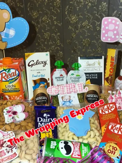 A closer look at the food hamper, showing the variety of branded chocolates and snacks included.