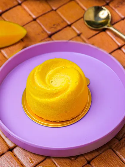 The Mango Delight, an elegant dessert featuring a mango baume mix and jelly on a delicate joconde sponge.