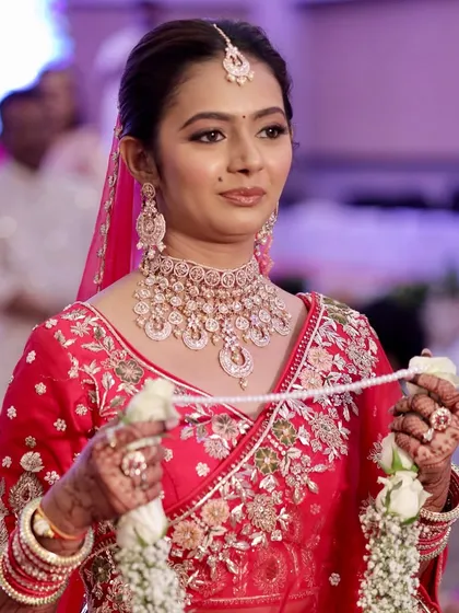 A candid moment during the wedding ceremony. The makeup is designed to be long-lasting and photograph beautifully, ensuring the bride looks fresh and radiant from the vows to the reception.