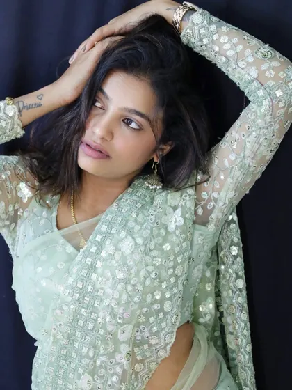 A beautiful shot of Sonu, with a tattoo peeking through the sheer sleeve of the blouse.