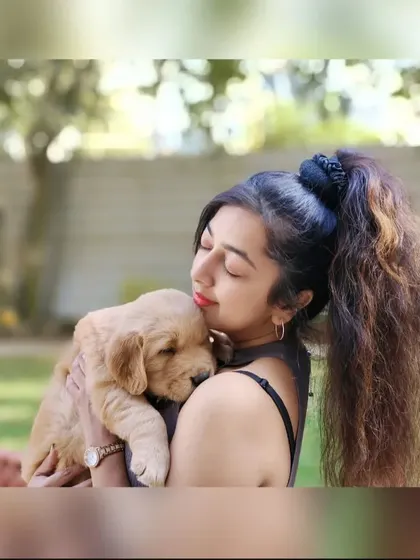 There's nothing like a puppy cuddle. Holding this sweet Golden Retriever pup close helps build a bond of trust and makes the grooming experience feel safe and comforting.