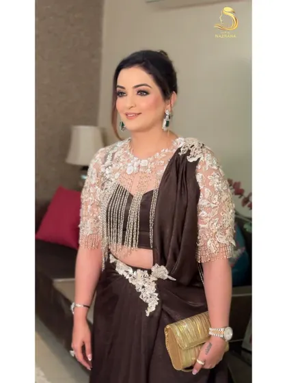 A beautiful client looking stunning with her textured French twist updo. It's a sophisticated choice that complements her embellished blouse perfectly.