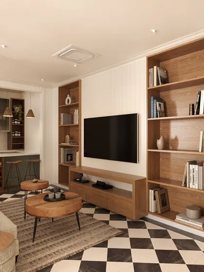 The lounge features floor-to-ceiling wooden bookshelves that provide ample storage and a warm, library-like feel. The comfortable seating and layered rugs make it the perfect spot for the family to relax.