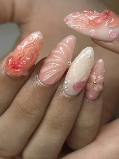 A stunning, ocean-inspired 3D nail art set. This design features sculpted shells, flowers, pearls, and water droplet effects in soft, beachy colors.