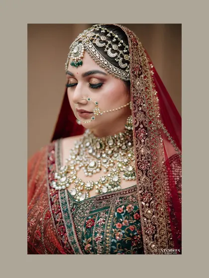 A close-up portrait of the bride, Rhea, showcasing her intricate bridal jewelry and flawless makeup.