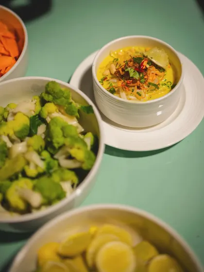 A bowl of Khow Suey with its accompaniments, showcasing the customizable nature of the dish.