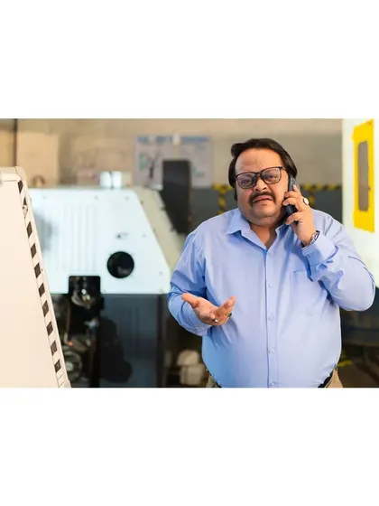 A candid-style commercial photograph for an ad campaign, showing a business owner on the phone. This approach helps create authentic and relatable visuals for brands.