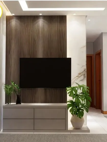 A close-up of the TV unit with a dark wood fluted panel and a simple, low-profile console.