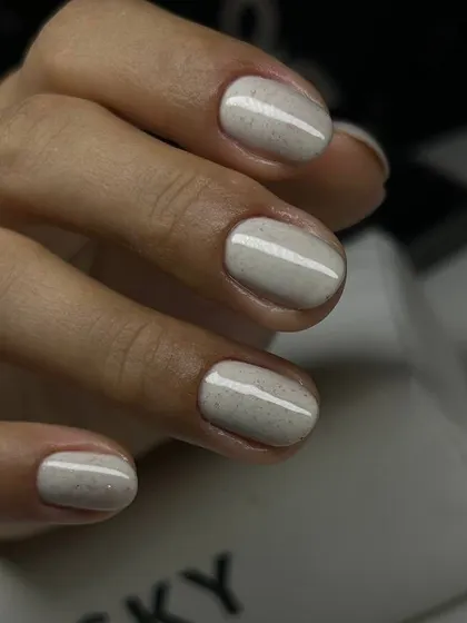 A lovely off-white manicure with a subtle speckled finish, like a quail's egg. This unique texture adds a touch of modern art to a neutral color.