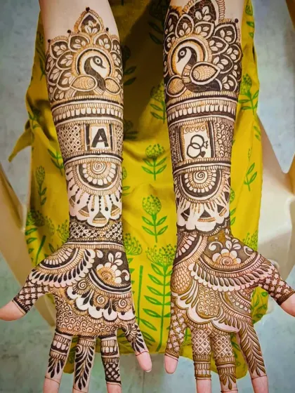 I specialize in personalizing your bridal mehandi. Here, I incorporated the groom's initial 'A' and a pair of elegant peacocks, which symbolize beauty and grace in Indian culture.
