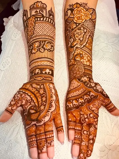 This design showcases a mix of peacock and elephant motifs, with varied patterns on each hand for a unique yet coordinated look.