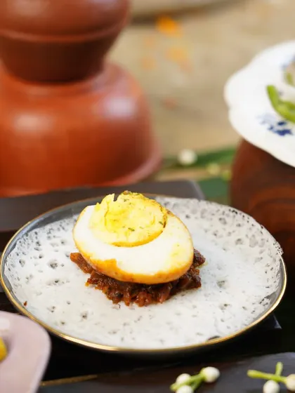 A classic Easter bite: a lacy appam topped with a spicy egg roast. This dish is a staple in Syrian Christian homes during the festival, representing new life and celebration.