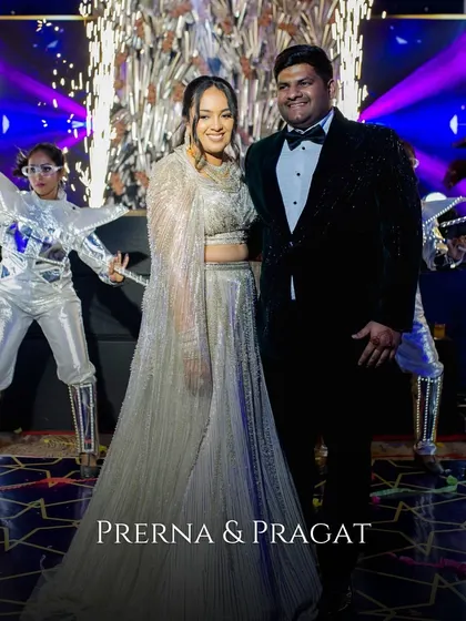 The couple poses with futuristic LED-costumed dancers, adding a high-tech and spectacular entertainment element to their Sangeet night.