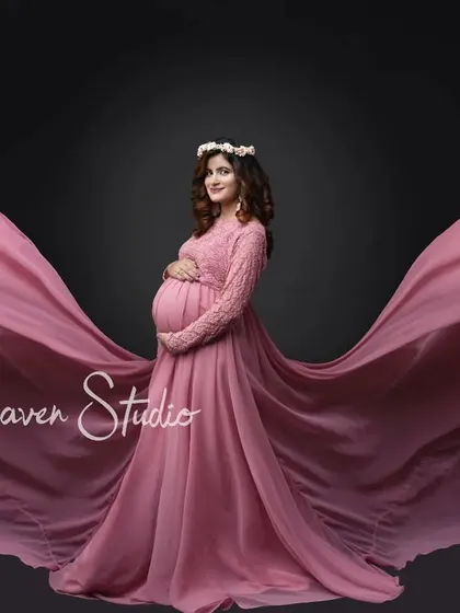 Let your spirit soar. I love using dramatic, flowing designer maternity gowns to create breathtaking silhouettes that celebrate your changing form. This studio shot in a beautiful pink dress captures a feeling of pure elegance and strength.