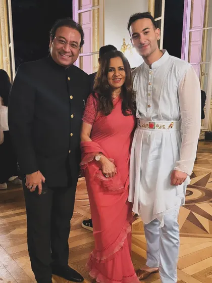 With my parents at the Paris event, a proud family moment.