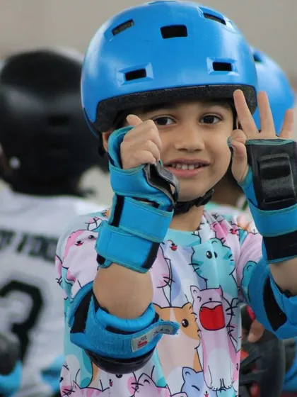 A happy skater giving a peace sign to the camera. Our classes are a place where kids can be themselves, have fun, and feel proud of what they are learning.