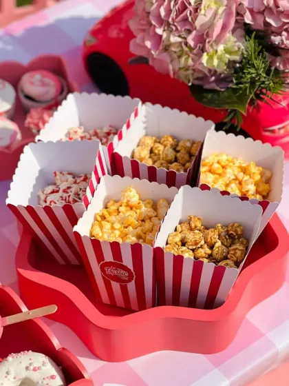 A star-shaped tray holding various flavors of popcorn, adding another fun geometric element to the tablescape.