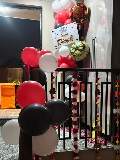 A balloon bouquet with a 'Happy Diwali' sign and themed foil balloons for a card party.