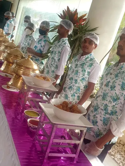 My professional team in uniform, standing by the buffet line. They are trained to maintain hygiene and provide courteous service throughout your event.