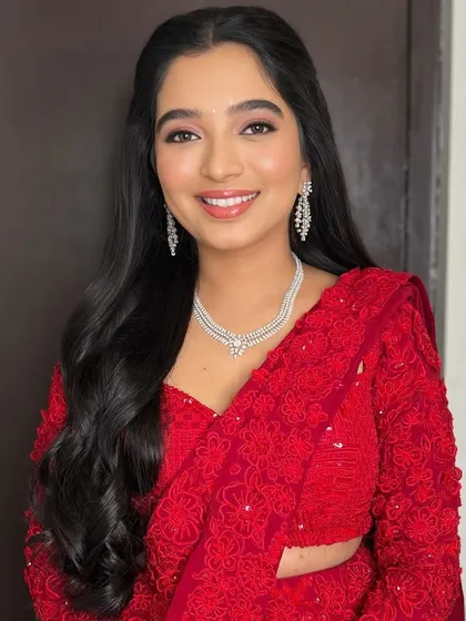 A close-up portrait showcasing the radiant smile and timeless makeup for a Sangeet night.