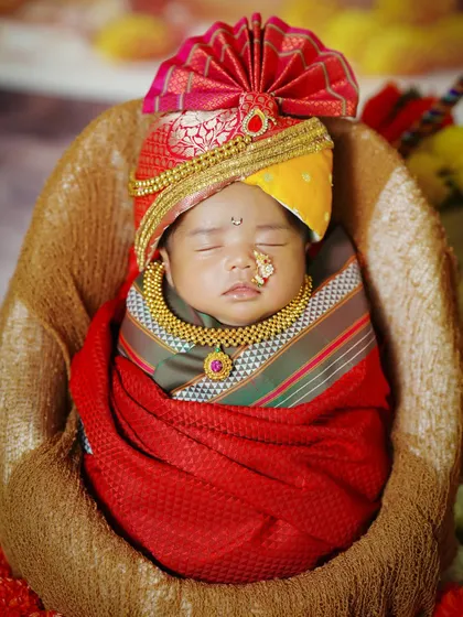 A close-up of the newborn in his festive Gudi Padwa attire, complete with a tiny nose ring and necklace.