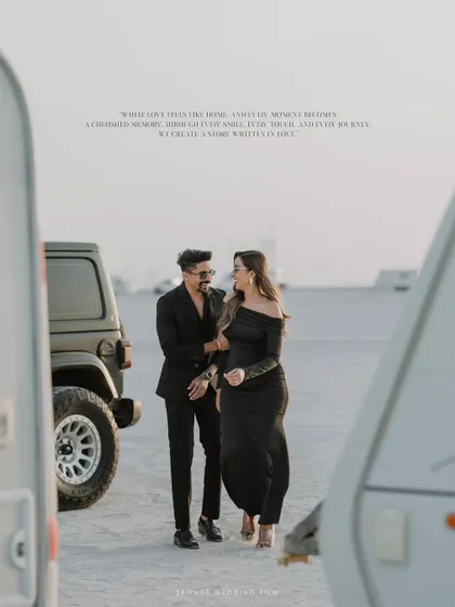A stylish shot of the couple walking in the desert, framed by two caravans, with a romantic quote overlaid to enhance the cinematic feel of their pre-wedding story.