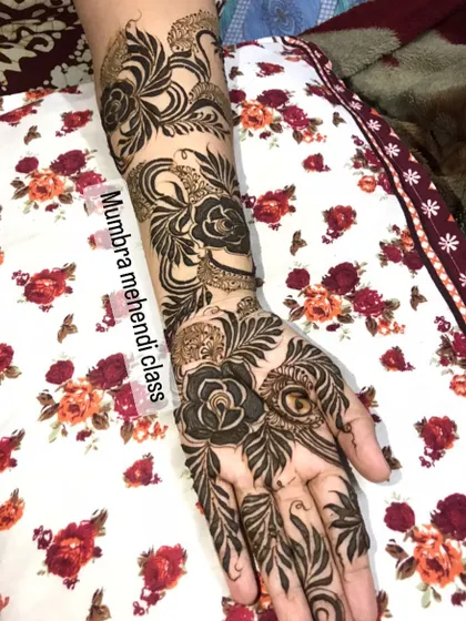 I love leaves! This design features swirling leaves and roses covering the hand and arm.