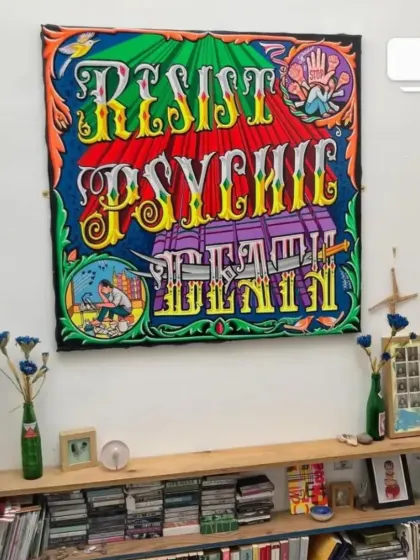 This custom typography piece, "Resist Psychic Death," is shown here as a wall hanging in a client's home. My paintings serve as unique and powerful statement pieces for interior decor.