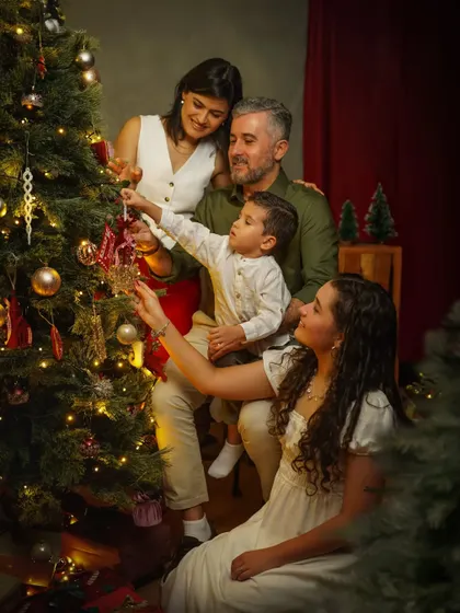 A beautiful family moment decorating the Christmas tree together. These are the memories that last a lifetime, captured in a warm, festive, and painterly style.