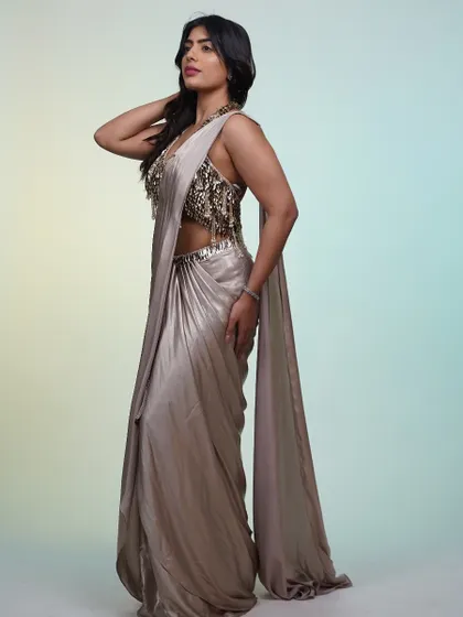 Side profile of the metallic saree, showing off the stunning, heavily embellished blouse. This is the kind of detail that makes a rented designer piece so worth it.