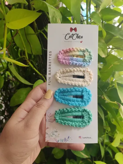 Our "Fun Barrettes" set, featuring four clips in cool tones of blue, green, and rainbow.