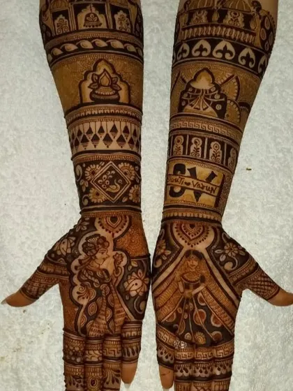 A romantic couple portrait on the palms, with the names "Sunil & Varun" integrated into the forearm design.