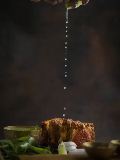 A squeeze of fresh lime over our Paneer Tikka just before serving. This simple touch brightens up all the smoky and spicy flavours of the dish.