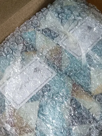 Even before the final wrap, I ensure every item is protected. Here, custom passport covers are carefully bubble-wrapped before being packaged.