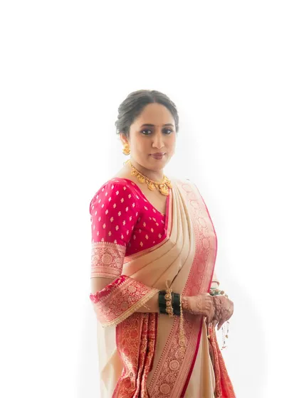 A clean, high-key studio-style portrait of the bride, focusing on her serene expression and the beauty of her traditional attire.