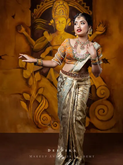 The full silhouette of this beautiful muhurtham saree. The way it is draped showcases the rich border and the intricate work on the blouse.