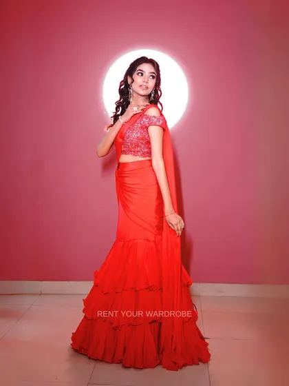 A full-length view of our stunning red ruffle drape saree, a perfect choice for a cocktail party or reception.