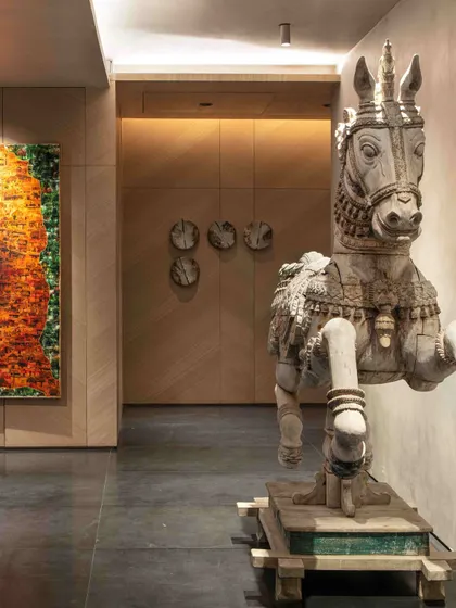 The antique horse sculpture from Kutch is positioned to greet visitors, its weathered form and intricate carving telling a story of time and travel. It is a prime example of how we use unique objects to build character in a space.