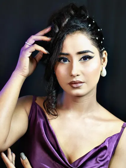 This image showcases the attitude and style of the party look, with a focus on the hair and makeup.