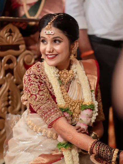 A candid moment during the ceremony. The makeup is designed to be picture-perfect, with a matte finish that prevents shine and ensures she looks flawless in every photograph.