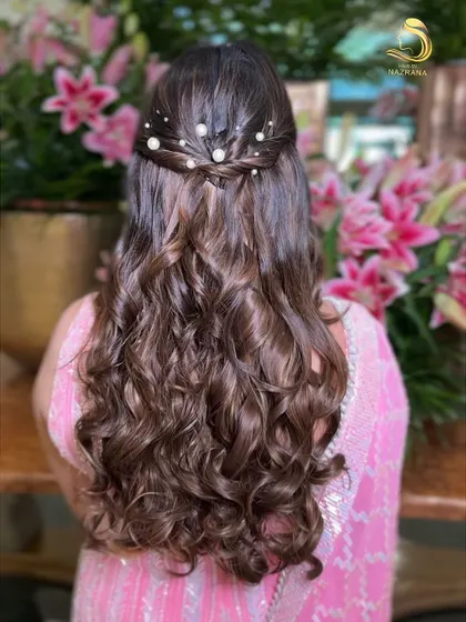 A closer look at the pearl-adorned half-updo, perfect for a bridesmaid or for an engagement party.