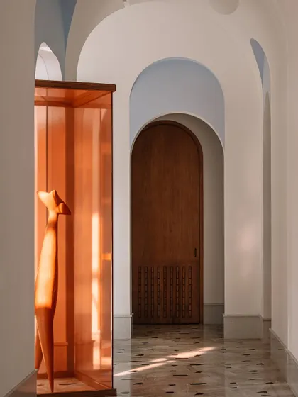Another perspective of the galleria, showing the play of light and the strong geometry of the arches and the art installation.