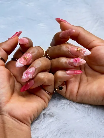 This set combines multiple advanced techniques, including 3D florals, encapsulation, and delicate gold charms, all created by our nail batch students.