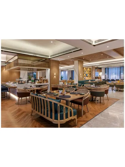 The all-day dining restaurant at Radisson Resort, designed with extensive seating to cater to large groups for conferences and weekend getaways. The layout includes a mix of banquette seating and freestanding tables, ensuring flexibility and comfort.