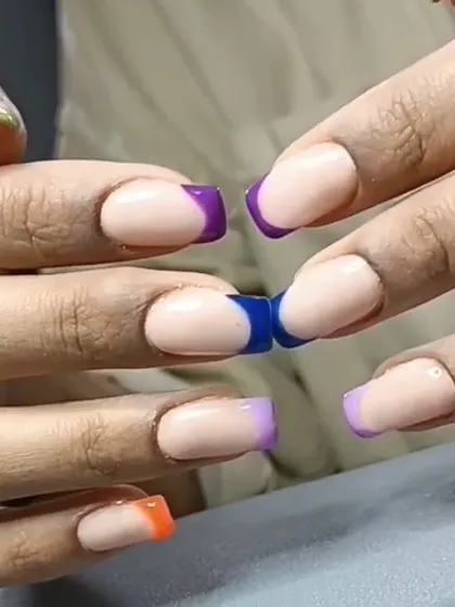A fun, multi-colored French tip design on short square nails, perfect for when you can't decide on just one color.